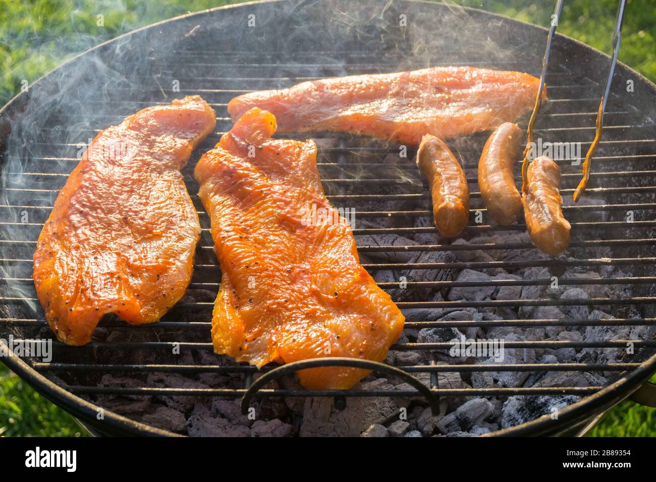Meat on a charcoal grill at a barbecue Stock Photo - Alamy