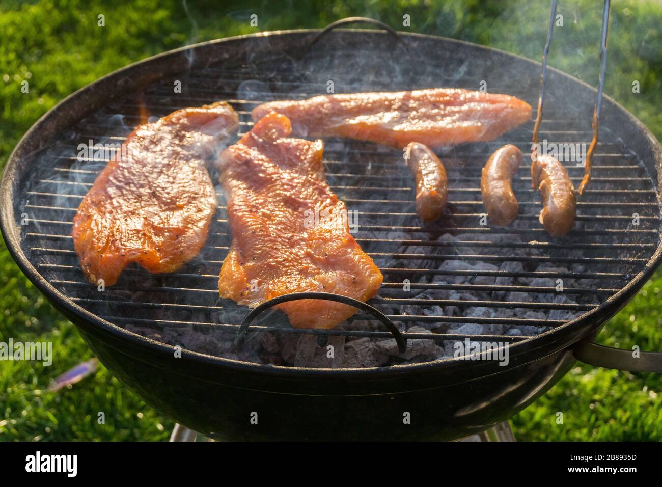 Meat on a charcoal grill at a barbecue Stock Photo - Alamy