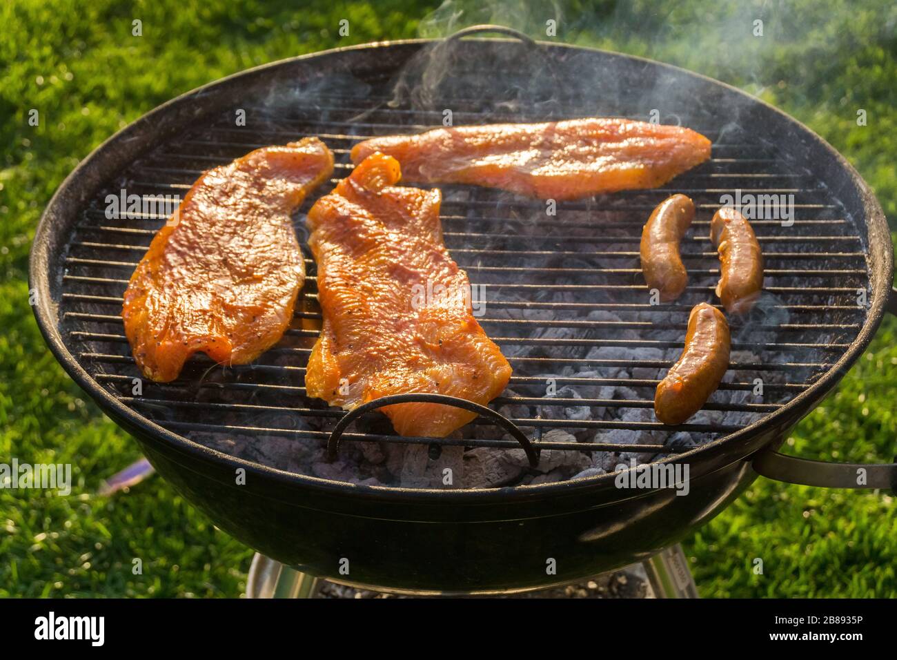 Meat on a charcoal grill at a barbecue Stock Photo - Alamy