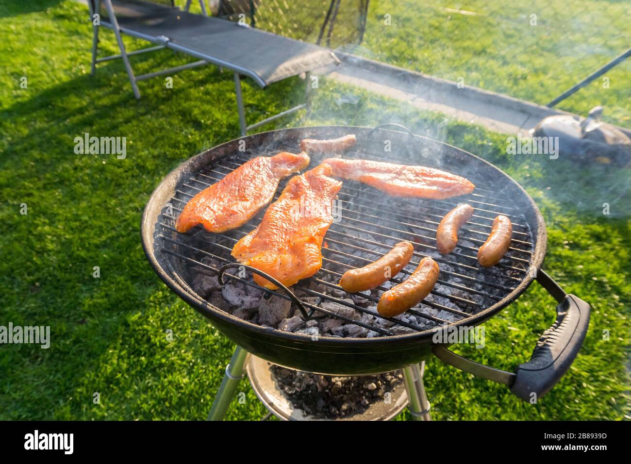 Meat on a charcoal grill at a barbecue Stock Photo - Alamy