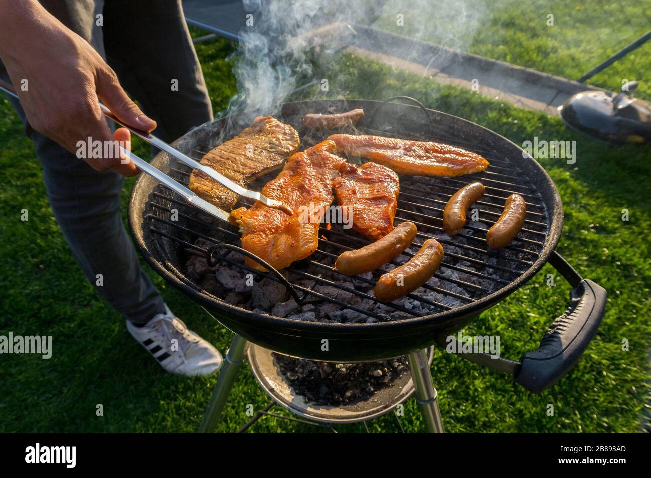 Meat on a charcoal grill at a barbecue Stock Photo - Alamy