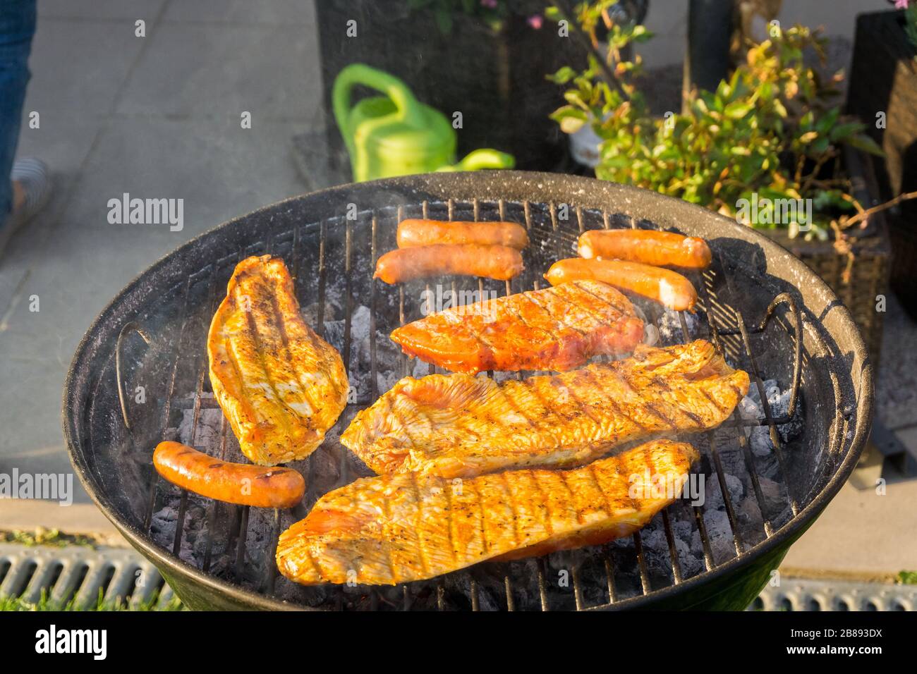 Meat on a charcoal grill at a barbecue Stock Photo - Alamy