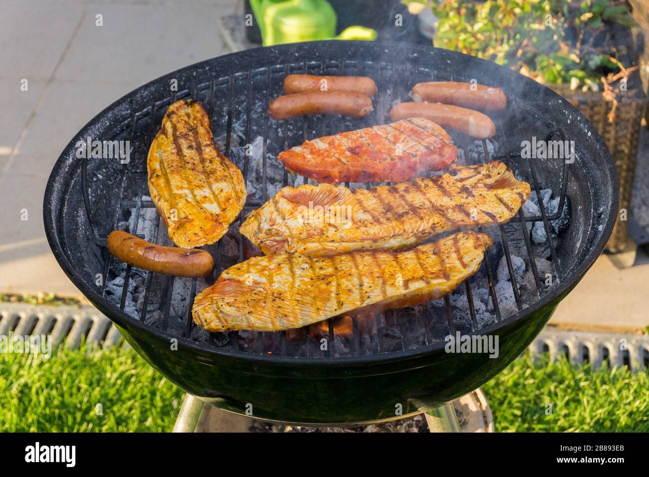 Meat on a charcoal grill at a barbecue Stock Photo - Alamy