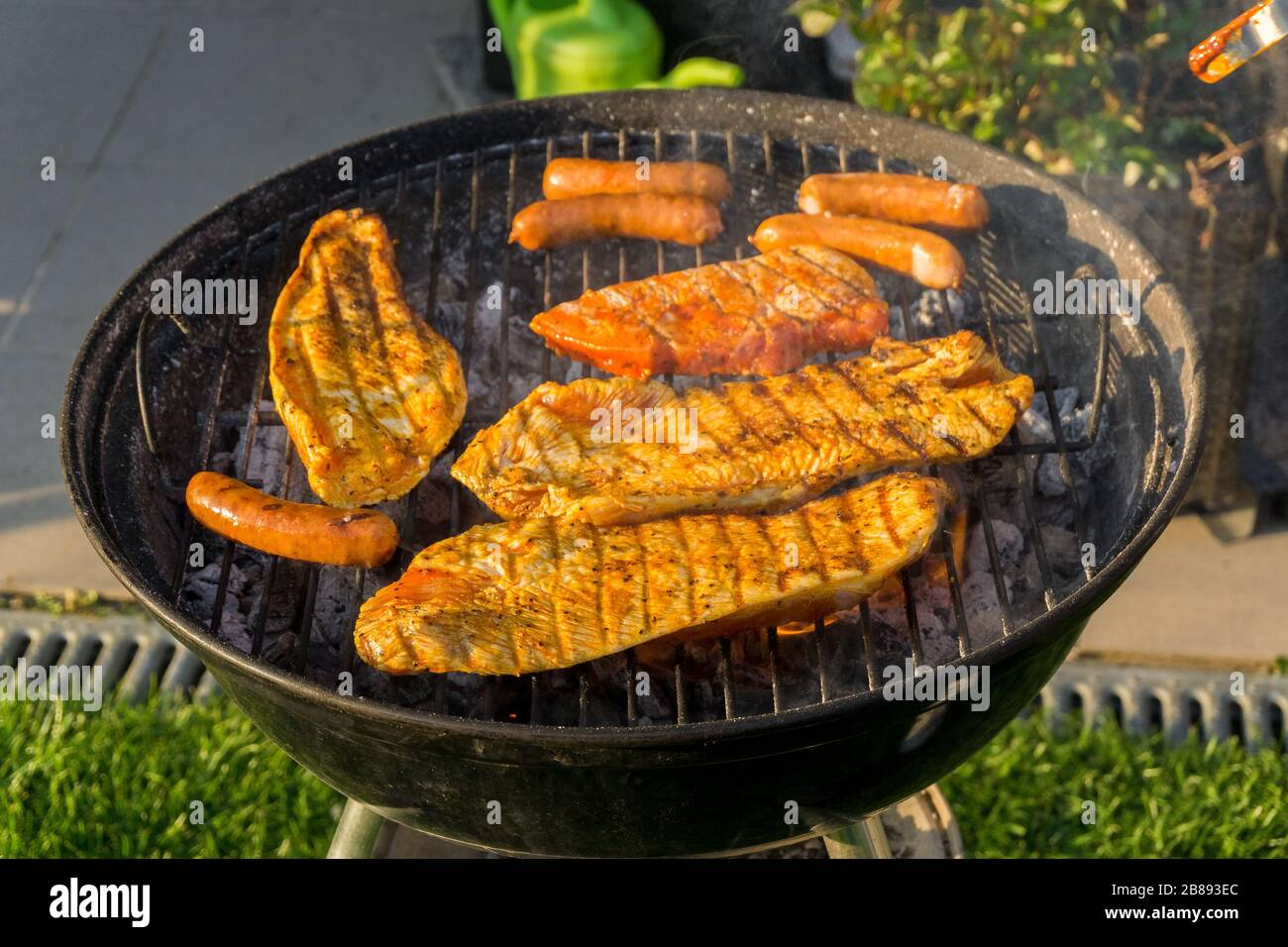 Meat on a charcoal grill at a barbecue Stock Photo - Alamy