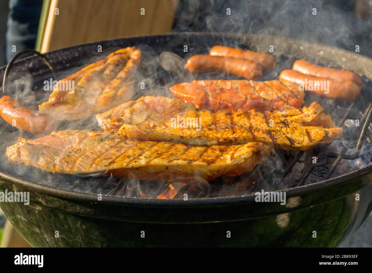 Meat on a charcoal grill at a barbecue Stock Photo - Alamy