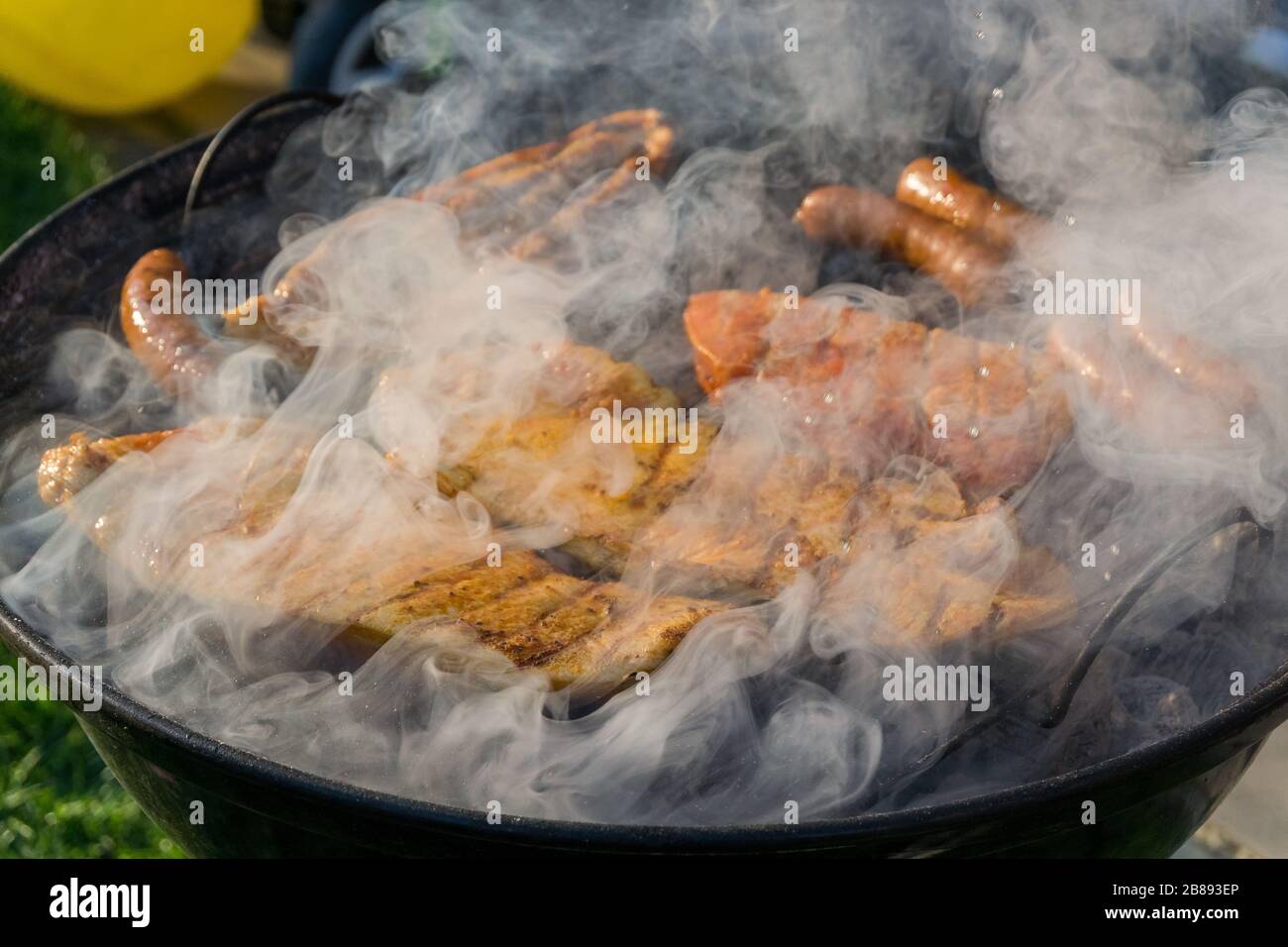 Meat on a charcoal grill at a barbecue Stock Photo - Alamy