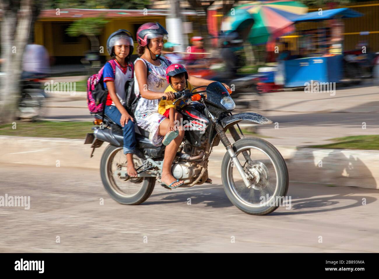 Three on a motorbike in Leticia, Amazon, Colombia, South America. Stock Photo