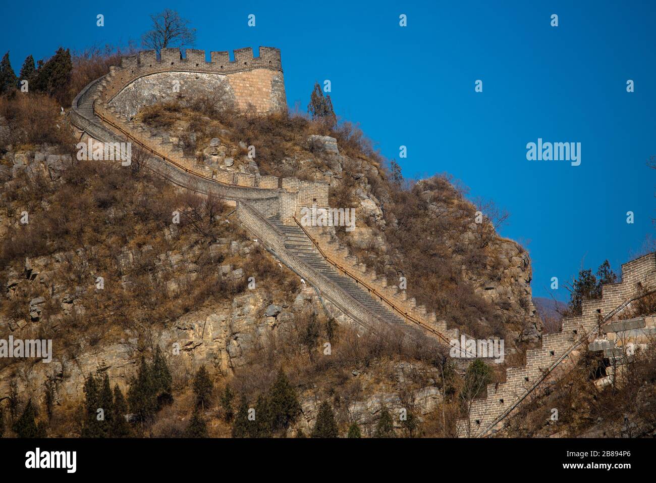 Sun sets on a blue sky day at the Great Wall of China, Beijing, China Stock Photo