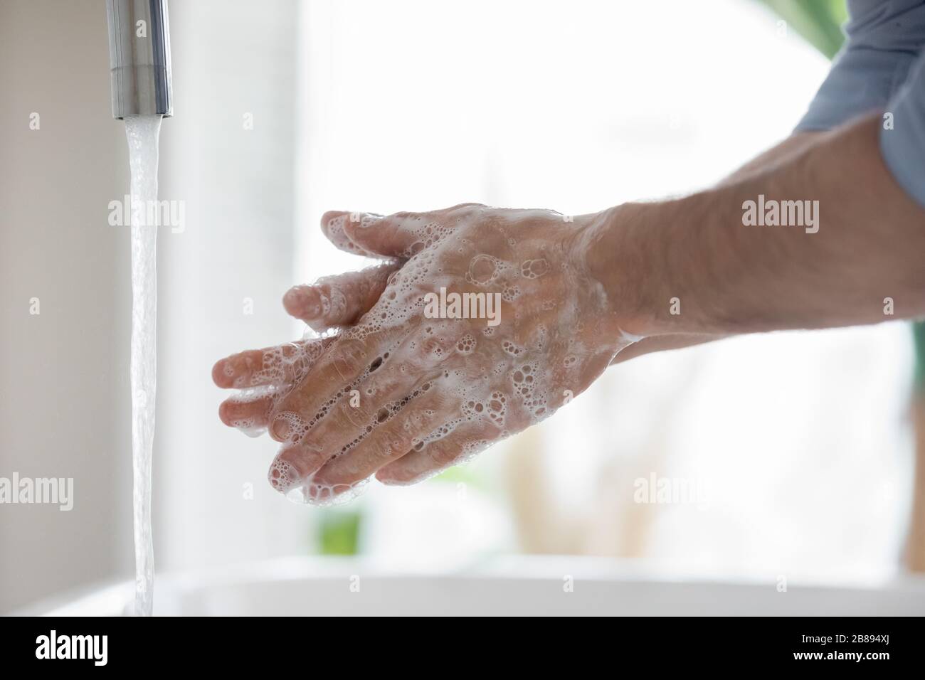 Closeup view guy cleans hands using anti bacterial agent Stock Photo
