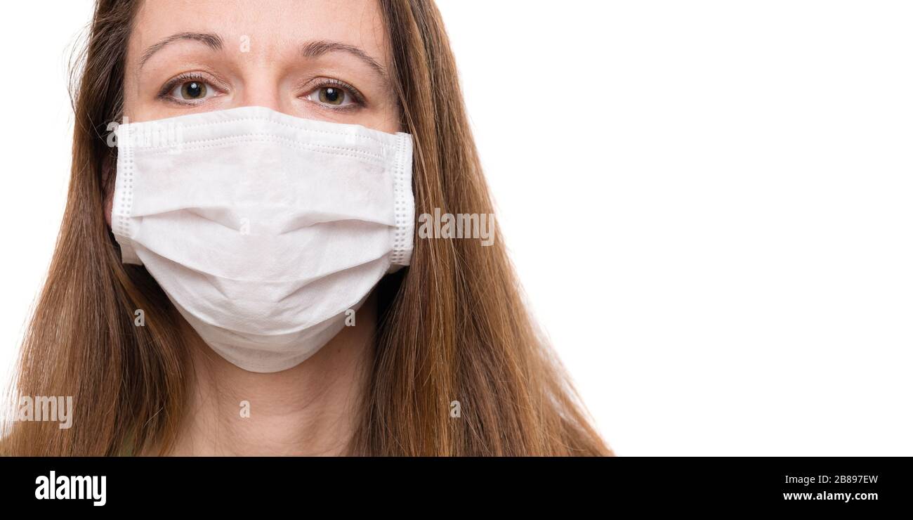 Young woman wearing protection face mask against coronavirus, isolated on white background Stock Photo