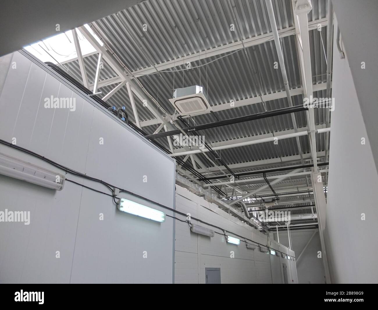 Pipelines of air conditioning and ventilation systems under the roof of the building above the cold rooms of the modern food market Stock Photo