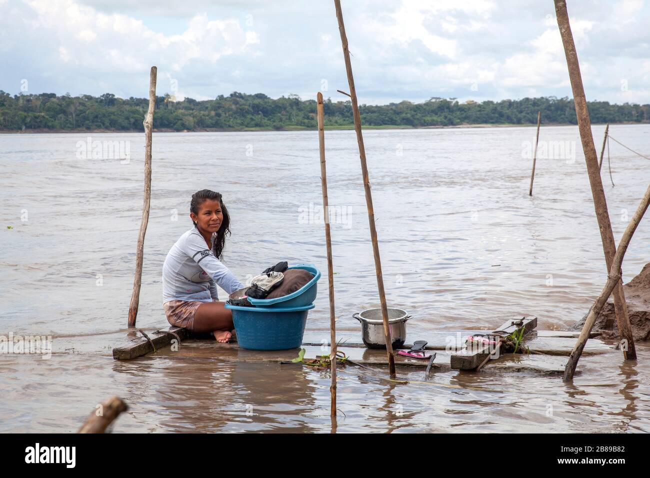 Indian woman doing the washing on the riverbank of the River Amazon, Peru, South America. Stock Photo