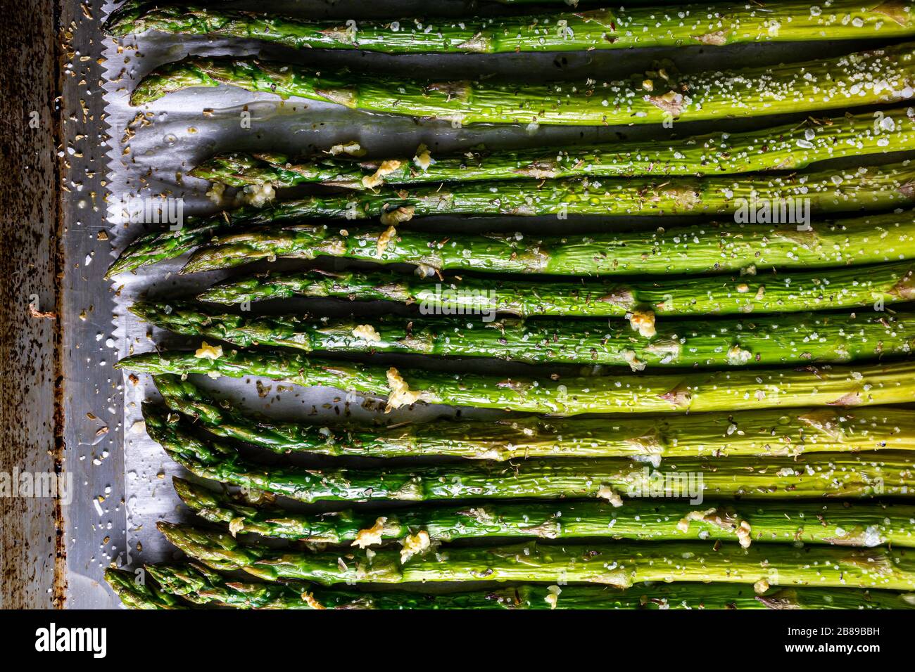 Asparagus spears on baking sheet pan. Stock Photo