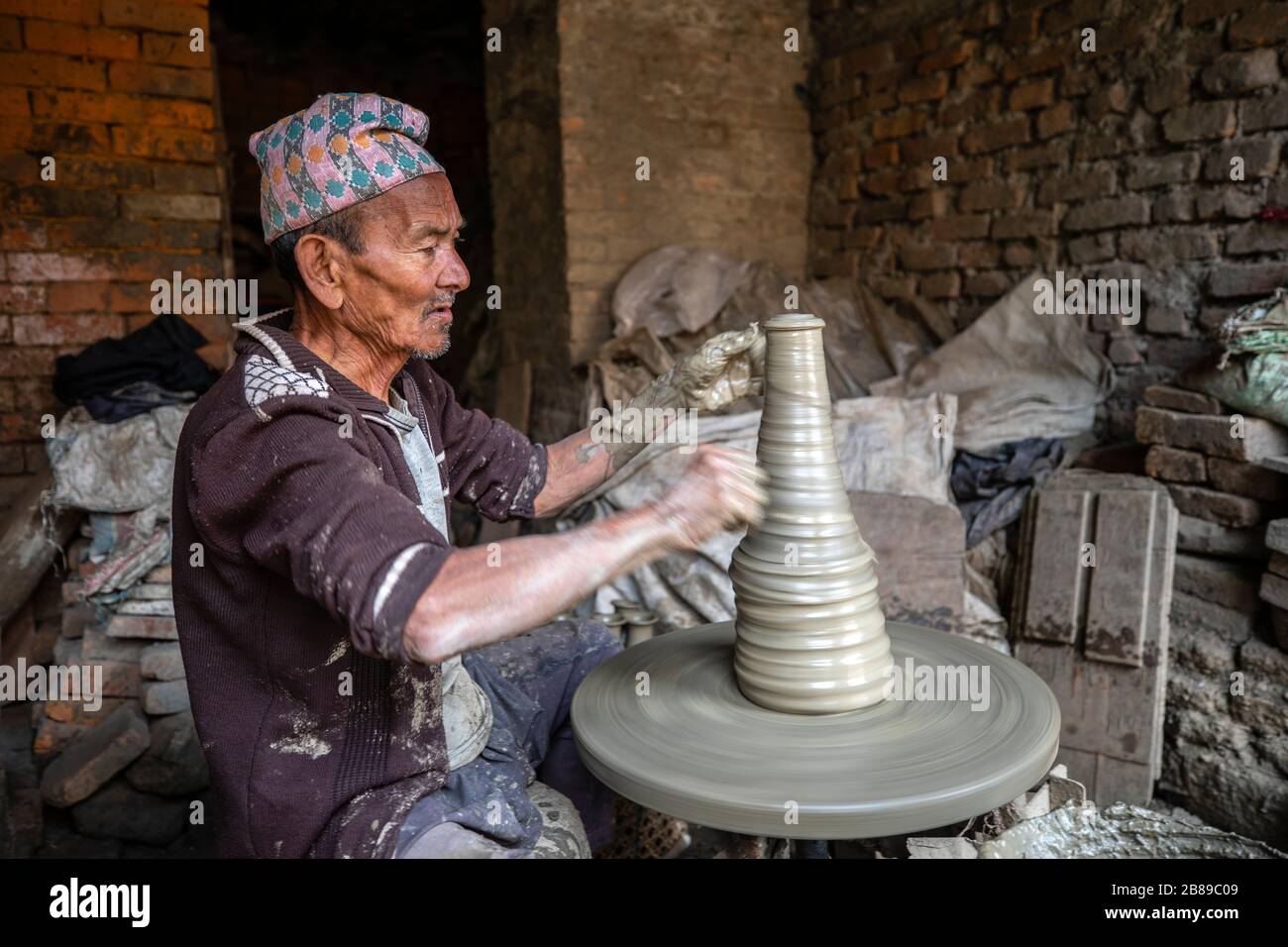 Man at potter's wheel in Bhaktapur, Nepal Stock Photo
