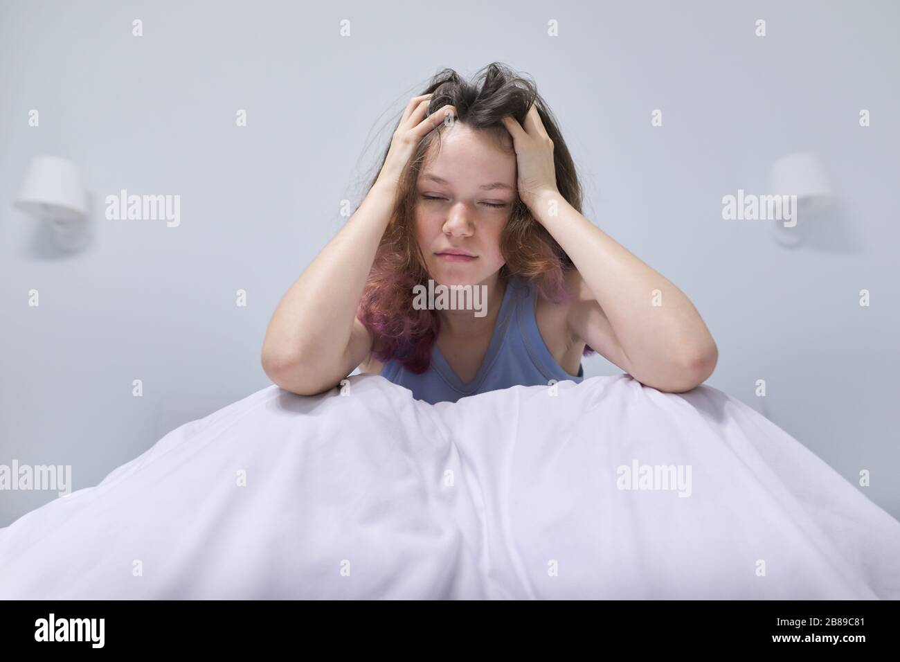 Sad teenager girl sitting at home in bed Stock Photo - Alamy