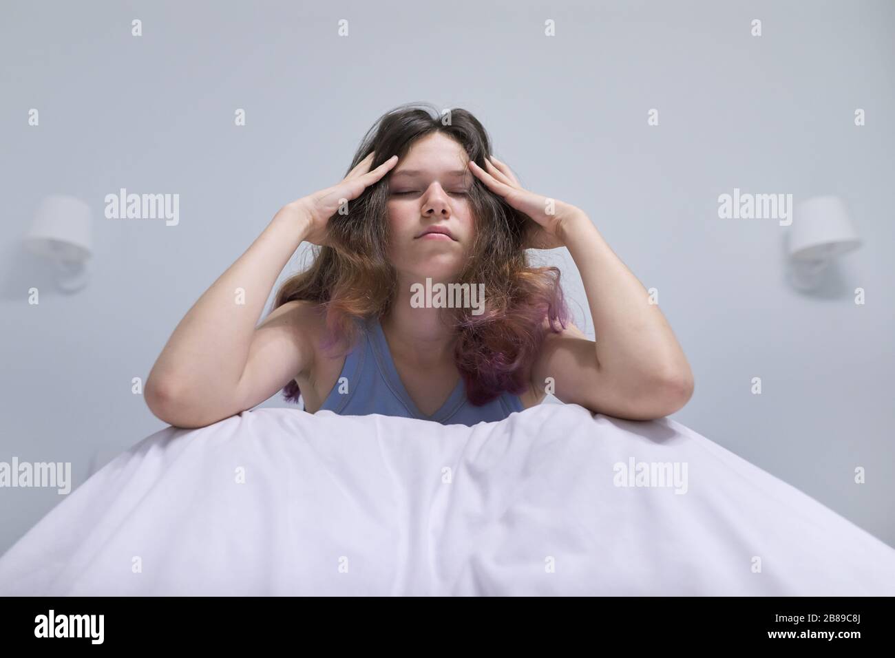 Sad teenager girl sitting at home in bed Stock Photo - Alamy