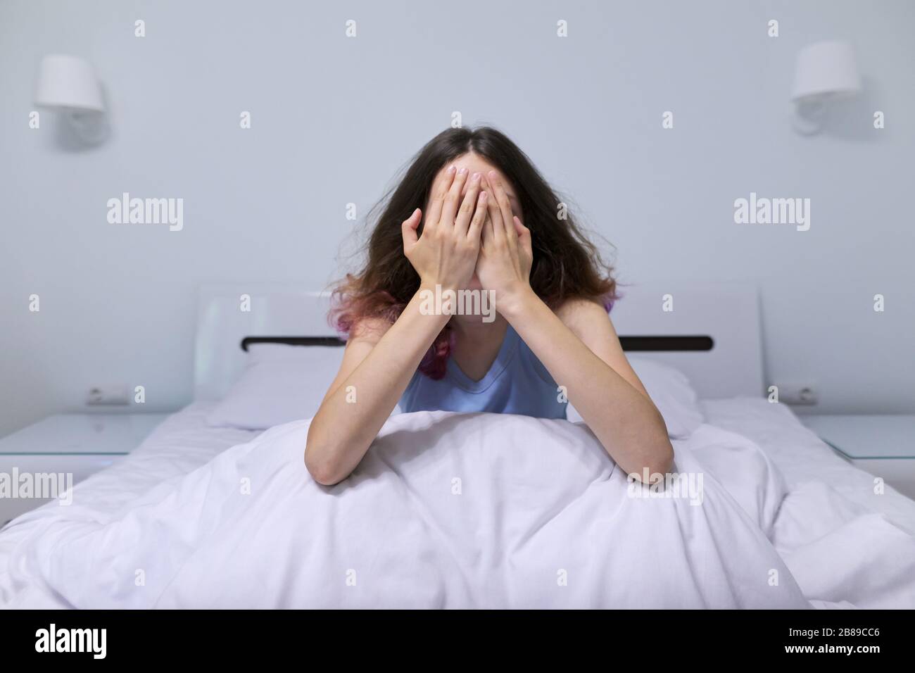 Sad teenager girl sitting at home in bed Stock Photo - Alamy