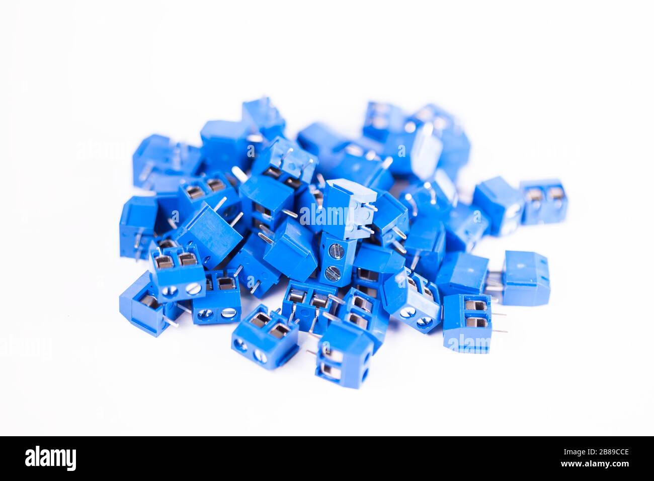 Close-up small blue connector parts lie on a white background. Concept for the production of powerful computers and printing equipment. Advertising sp Stock Photo