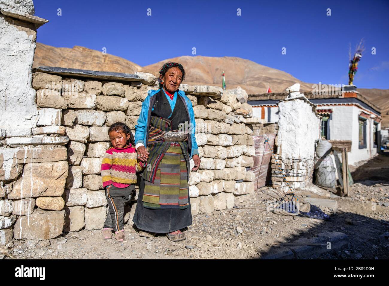 Tibetan grandmother with granddaughter in rual village of Manpu near Gyirong, Tibet Stock Photo