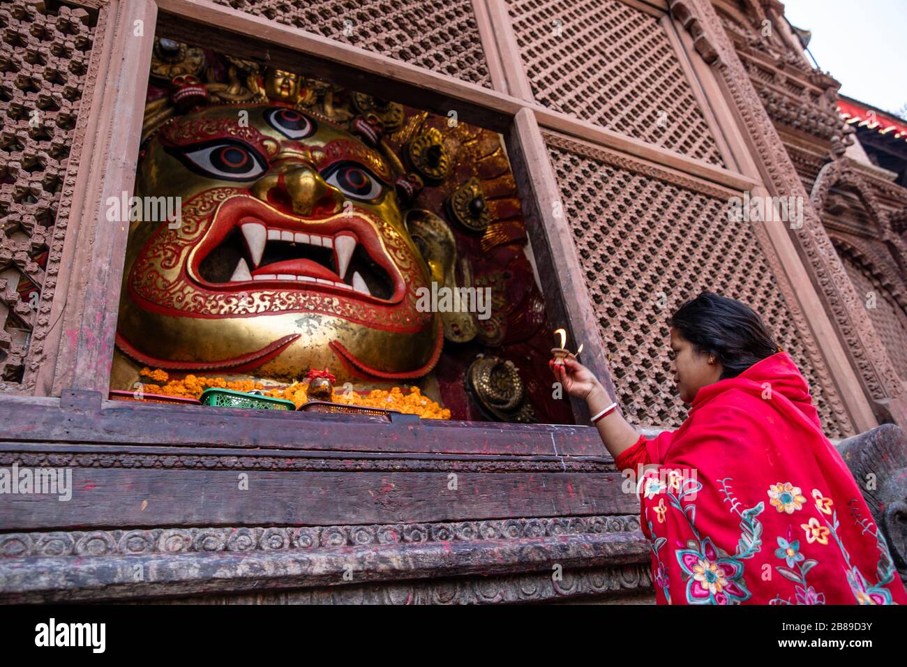 Hindu woman making Bhairab ritual offering at Jagannath Temple in Kathmandu, Nepal Stock Photo