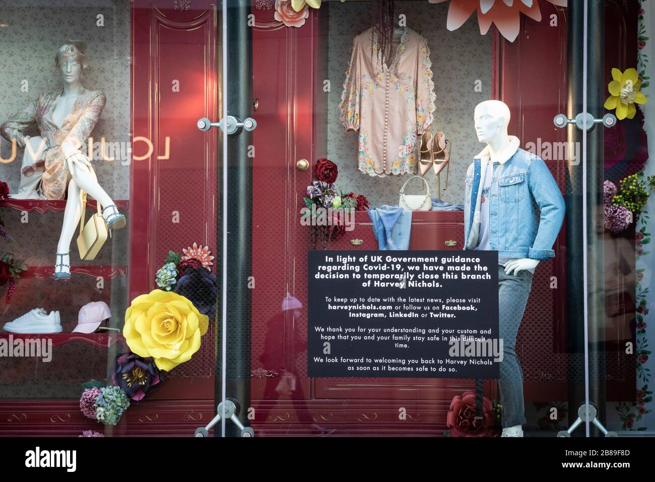 Manchester, UK. 20 March, 2020. A sign explaining the recent suspension of trade due to coronavirus is displayed in the window of the prestigious retailer Harvey Nichols. Credit: Andy Barton/Alamy Live News Stock Photo