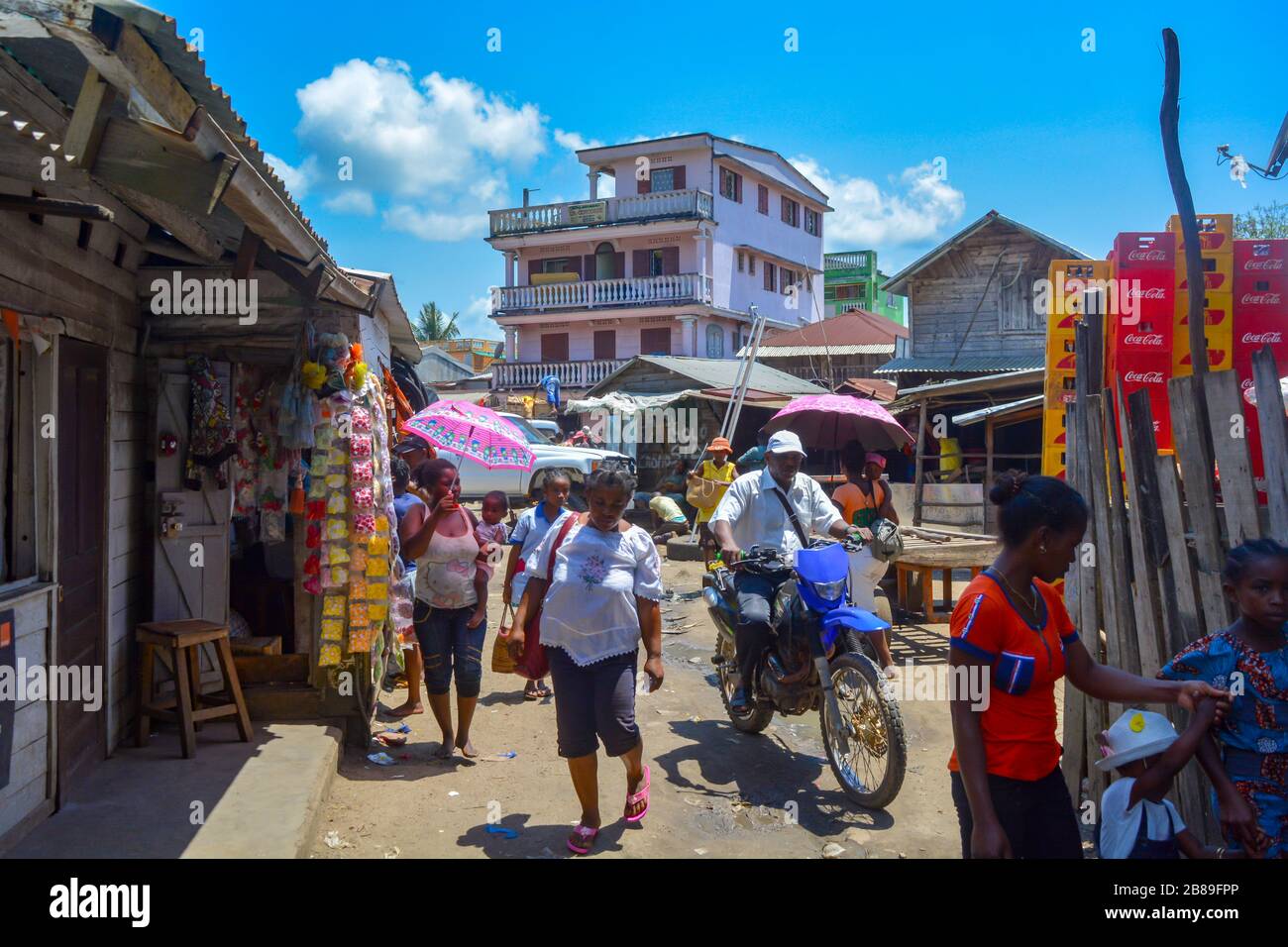 Soanierana Ivongo, Madagascar, Africa 01/08/20: African black people walking in the chaotic and dusty street of a small coastal town, colorful relax Stock Photo