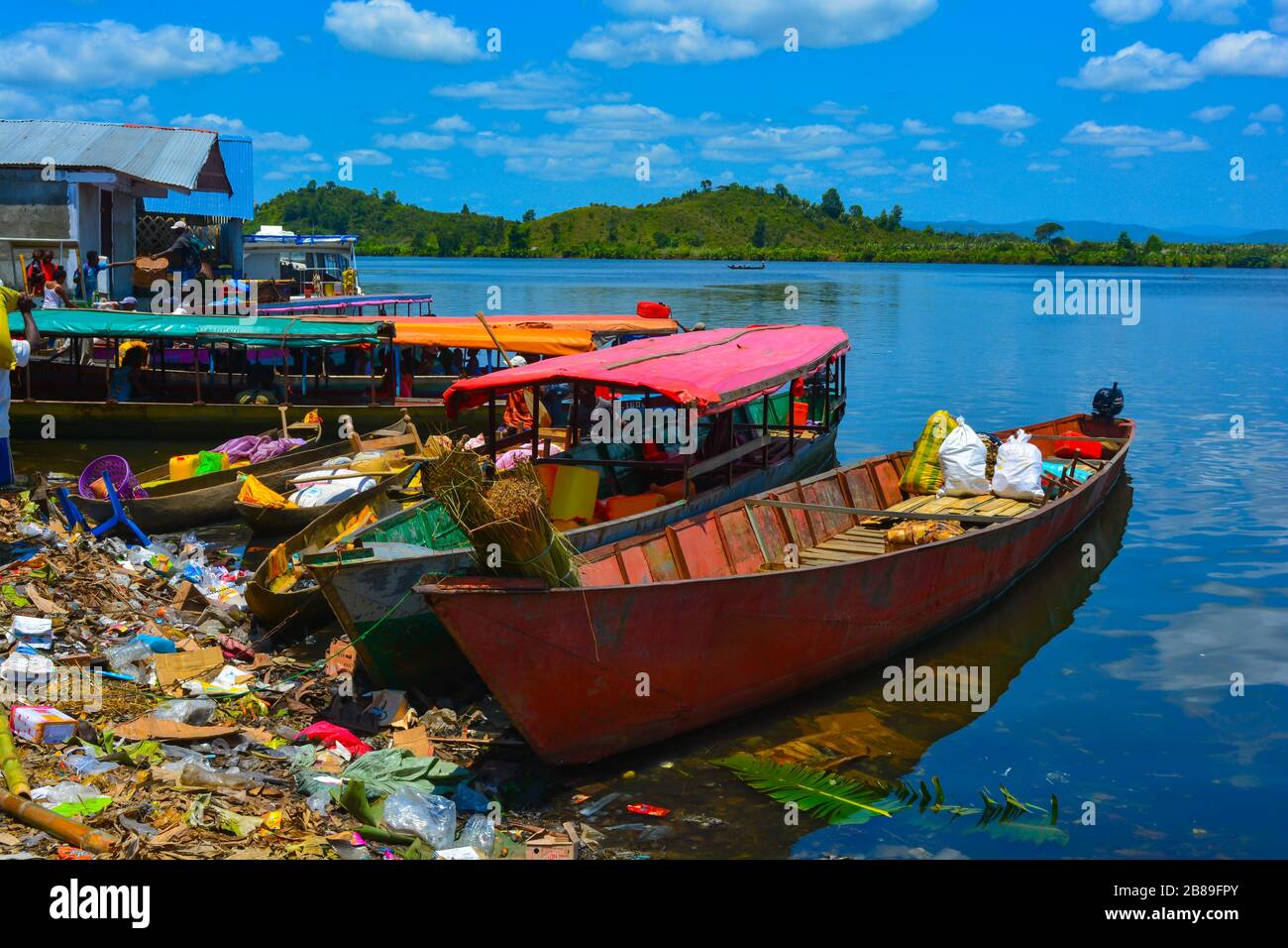Madagascar, Africa - 09/01/20: A colorful scene from a poor, dirty and very polluted african small port.Rusty old boats and ships, environmental issue Stock Photo