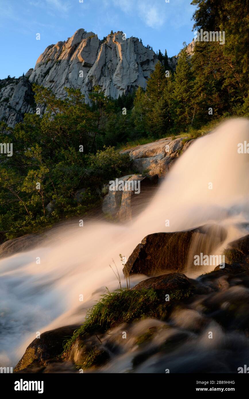 Evening light and waterfall below West Bell Tower in the Wasatch mtns. Stock Photo