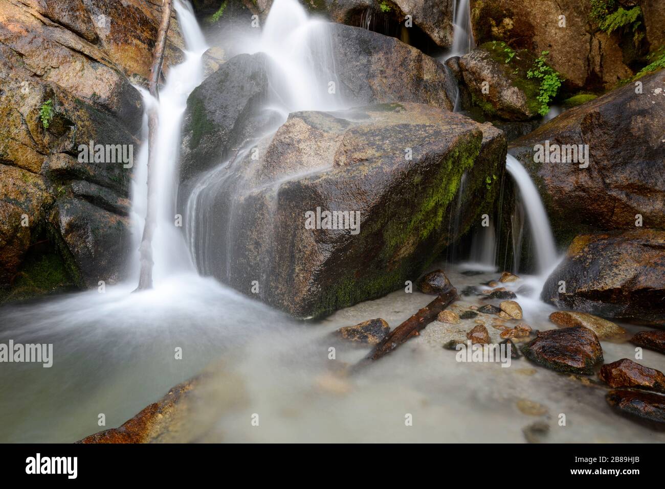 Water flows over and between rocks in Bells Canyon in the Wasatch Mtns Stock Photo
