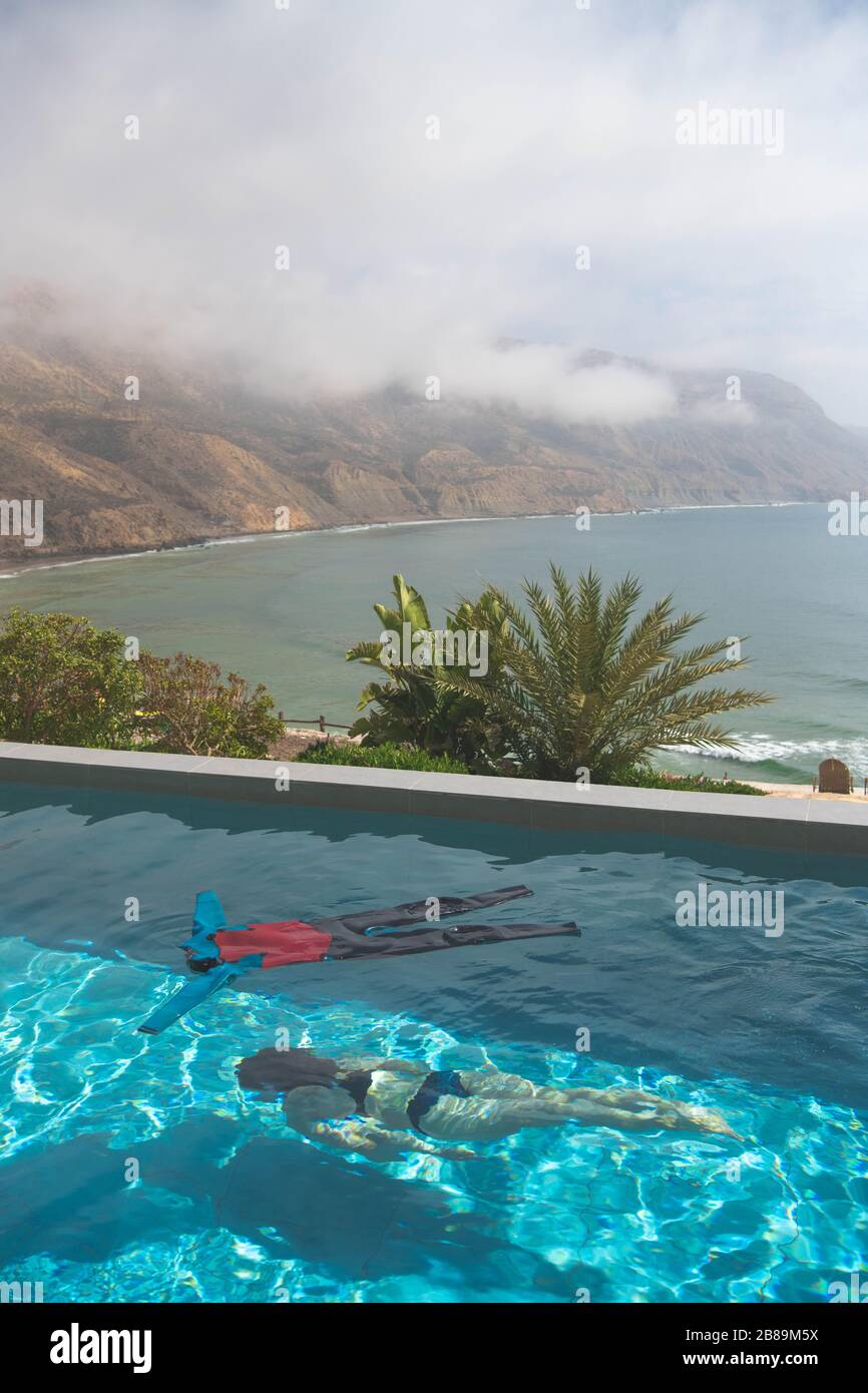 A woman dives under a wetsuit in a swimming pool Stock Photo Alamy