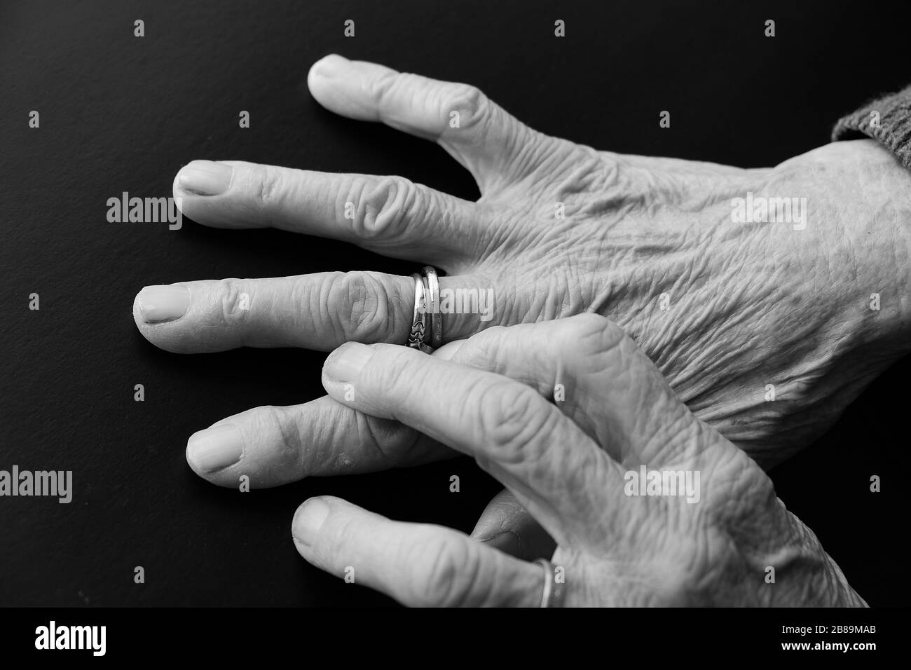 elderly woman's hand with a ring on her finger, old woman's hand and fingers, Stock Photo