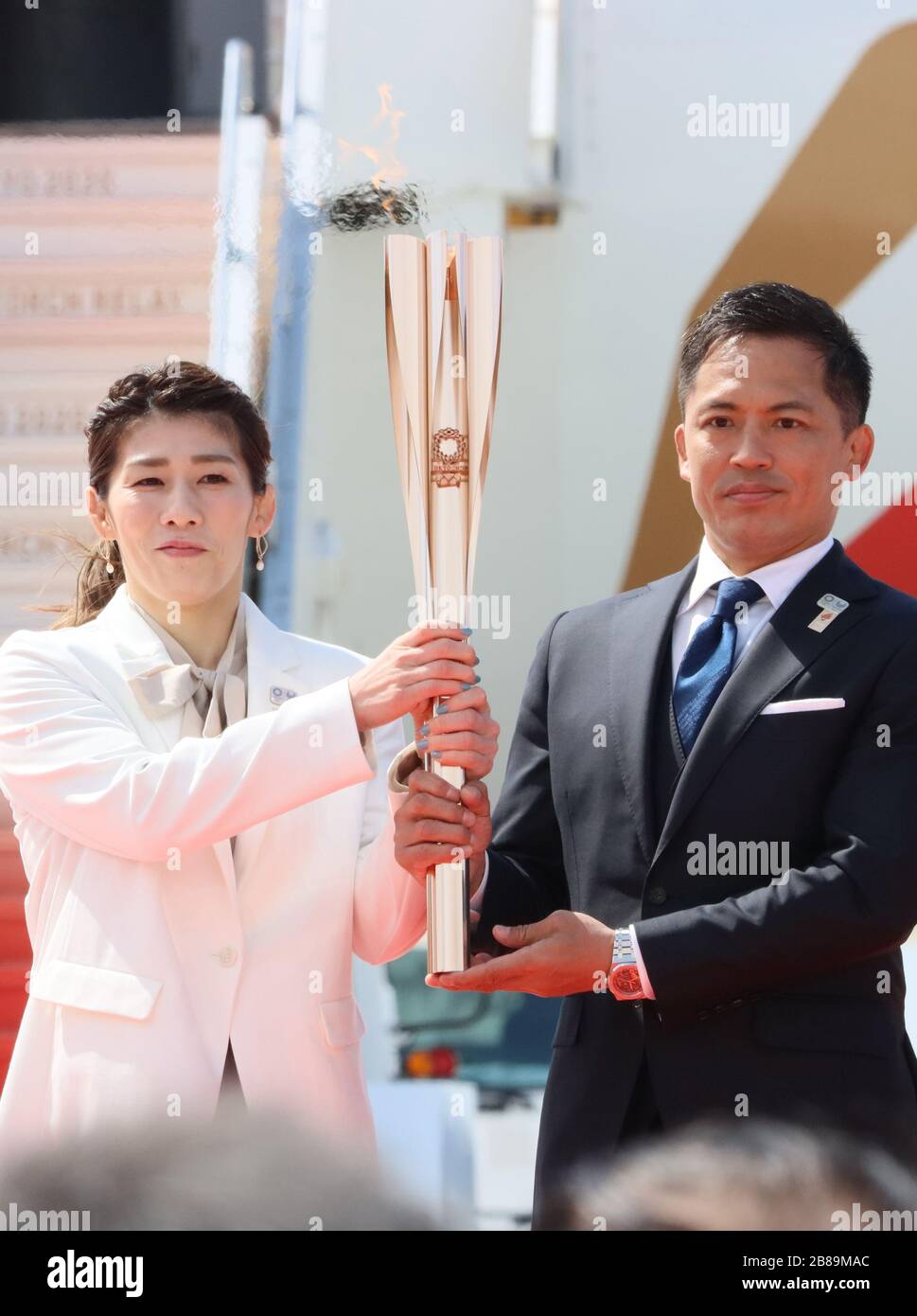 Higashi Matsushima, Japan. 20th Mar, 2020. Olympic gold medalists Saori Yoshida (L) of wrestling and Tadahiro Nomura (R) of judo hold a torch as they attend the arrival ceremony for the Olympic flame at the Matsushima air base in Higashi Matsushima in Miyagi prefecture, northern Japan on Friday, March 20, 2020. Tokyo 2020 Olympic Games will start from March 26 at Fukushima prefecture. Credit: Yoshio Tsunoda/AFLO/Alamy Live News Stock Photo