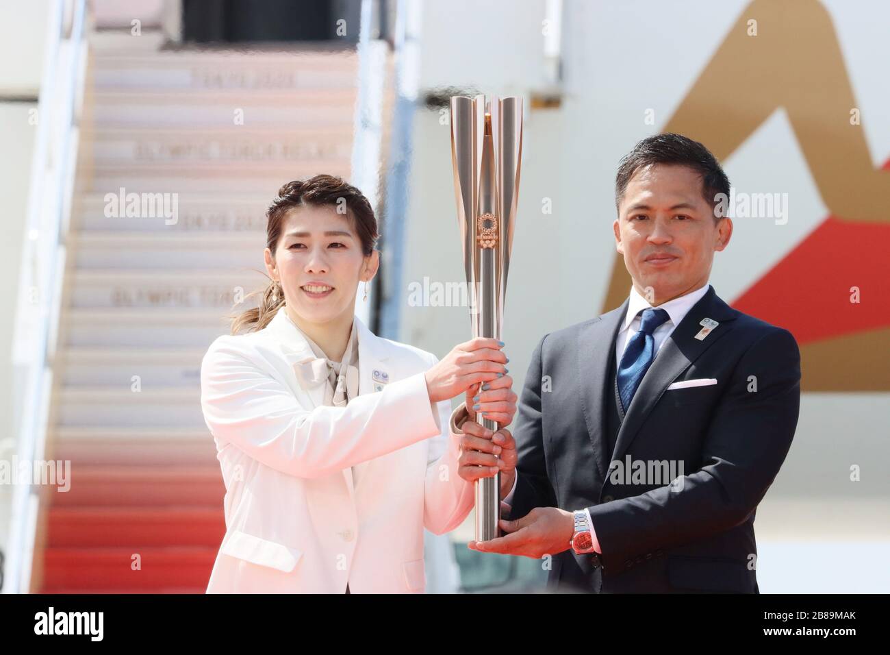 Higashi Matsushima, Japan. 20th Mar, 2020. Olympic gold medalists Saori Yoshida (L) of wrestling and Tadahiro Nomura (R) of judo hold a torch as they attend the arrival ceremony for the Olympic flame at the Matsushima air base in Higashi Matsushima in Miyagi prefecture, northern Japan on Friday, March 20, 2020. Tokyo 2020 Olympic Games will start from March 26 at Fukushima prefecture. Credit: Yoshio Tsunoda/AFLO/Alamy Live News Stock Photo