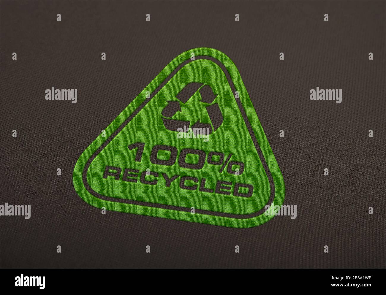 Recycle logo embroidered on cloth background. Stock Photo