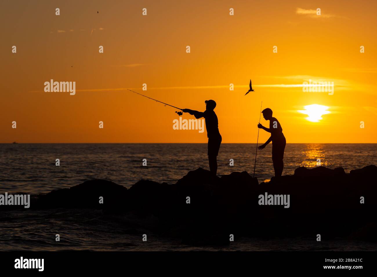 Two boys fishing coast hi-res stock photography and images - Alamy