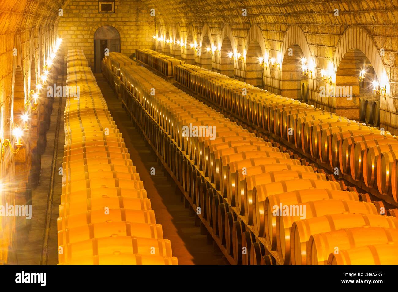 Wine barrels stacked in the cellar of the winery Stock Photo - Alamy