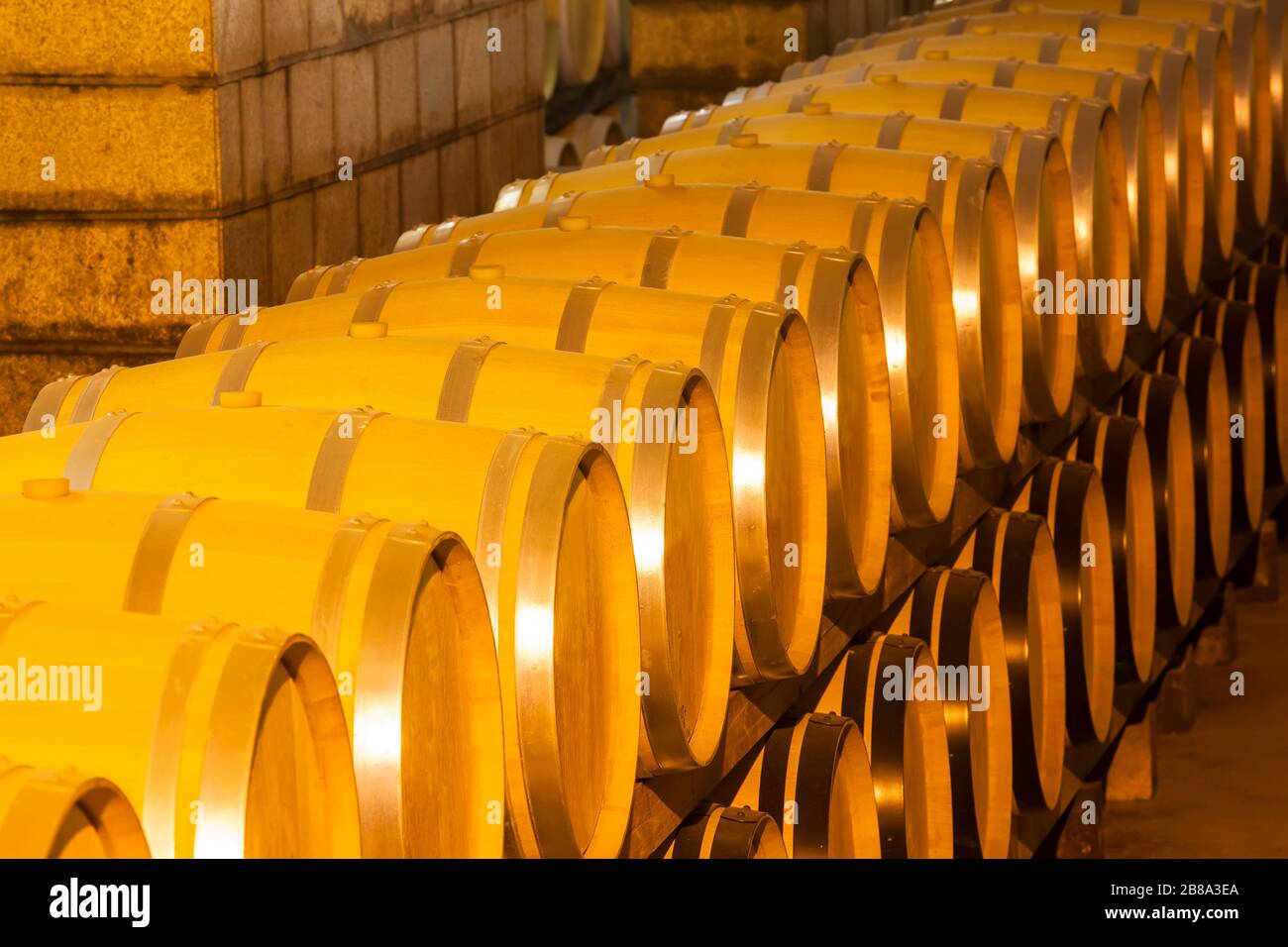 Wine barrels stacked in the cellar of the winery Stock Photo - Alamy