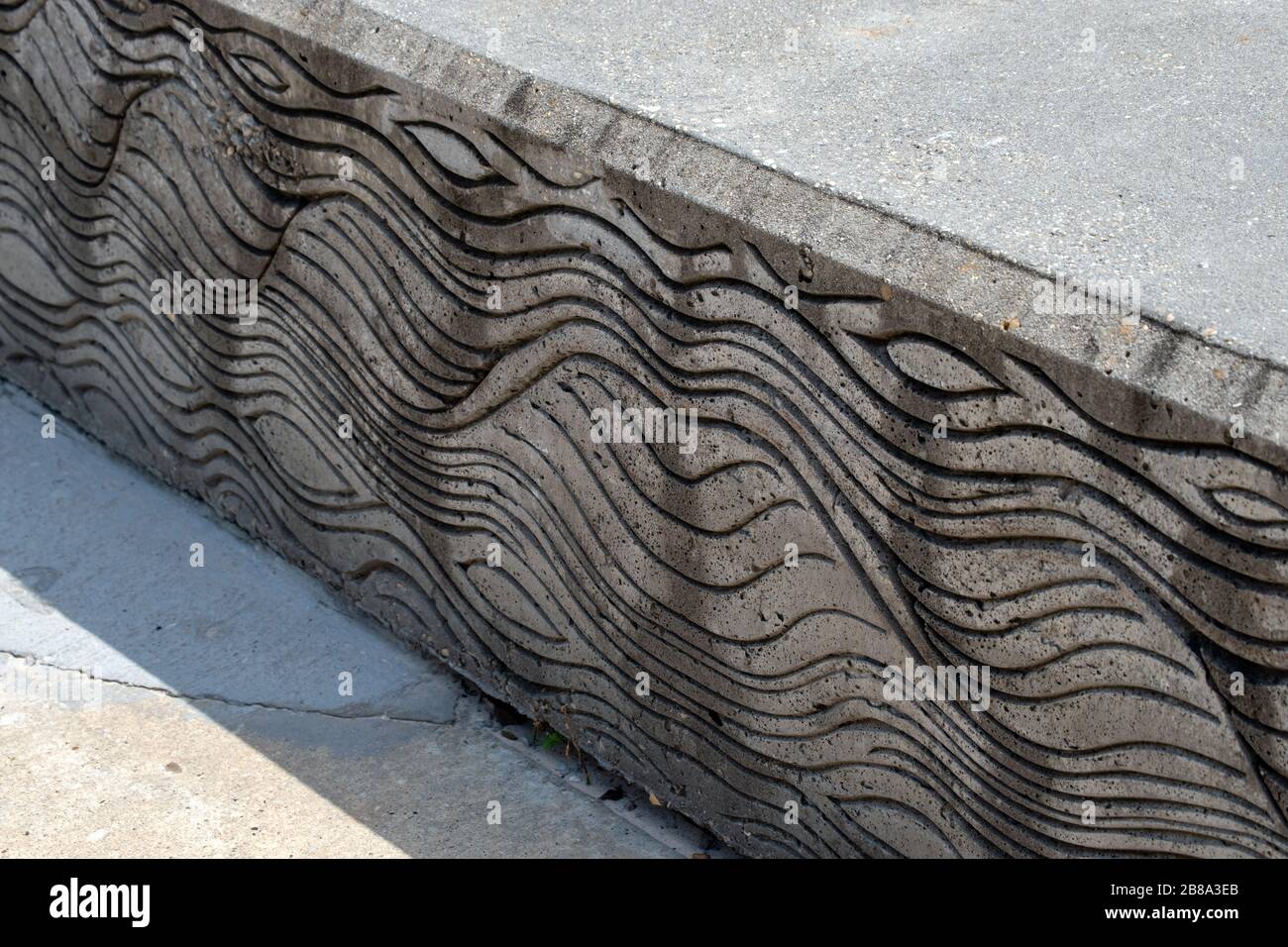 An interesting wavy line pattern on a cement wall. Bokeh effect and available copy space. Stock Photo