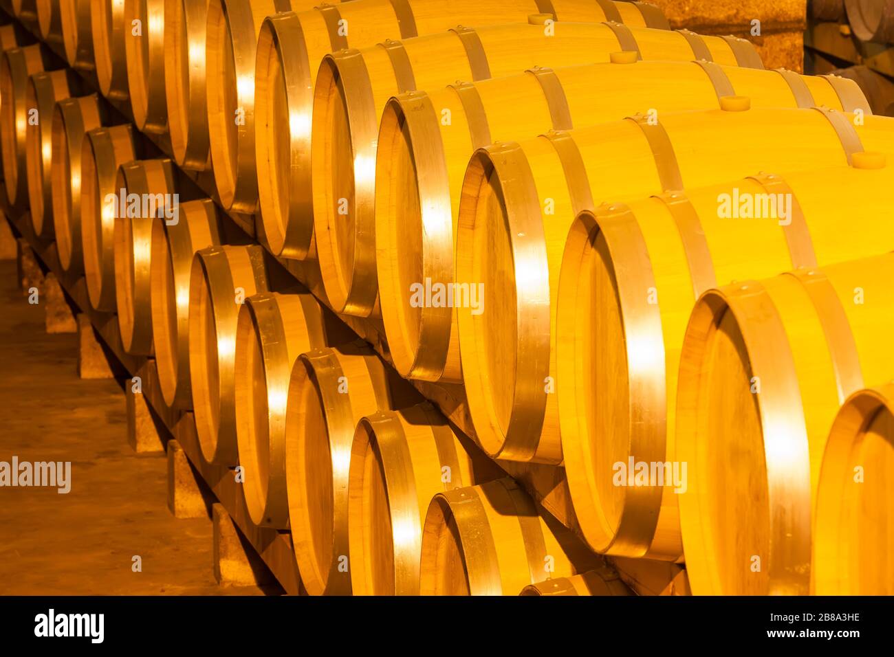 Wine barrels stacked in the cellar of the winery Stock Photo Alamy