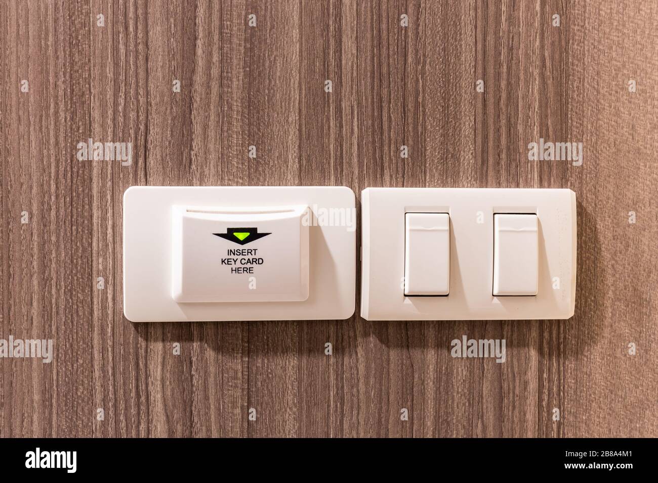 key card holder and light switches in hotel room for Control electrical  systems and room safety on wood wall Stock Photo - Alamy