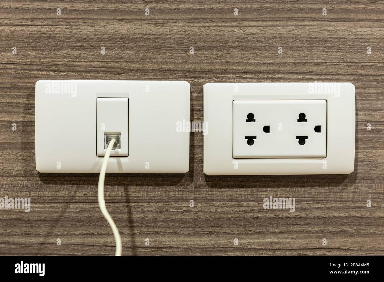 Wall socket and telephone wall socket in room for plug or phone jack