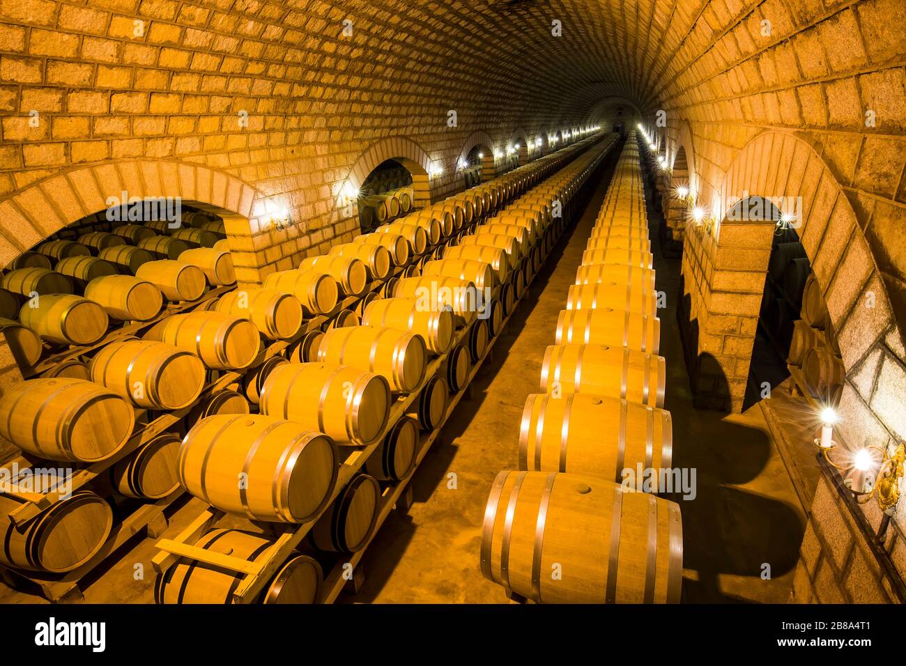 Wine barrels stacked in the cellar of the winery Stock Photo - Alamy
