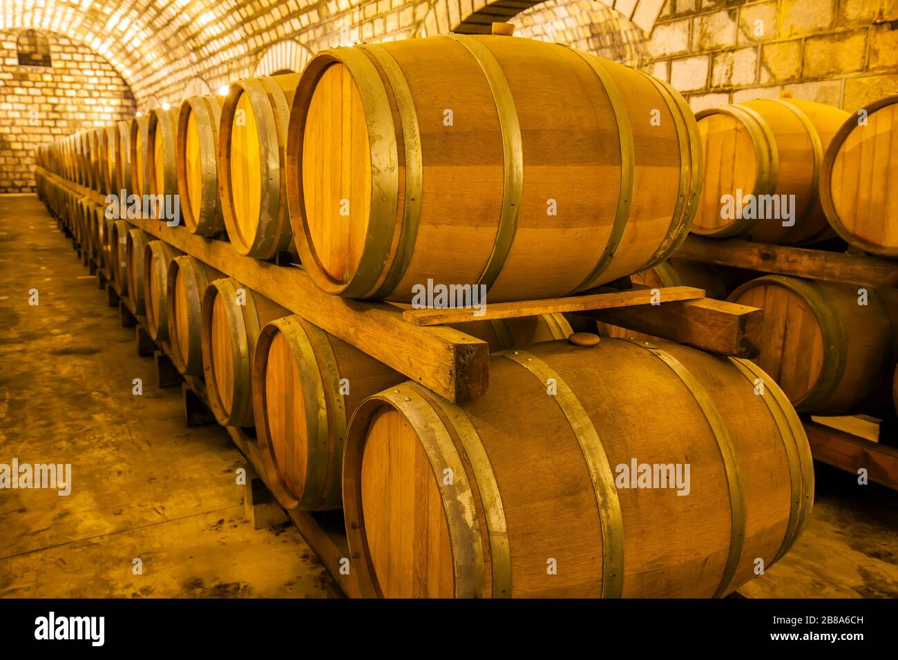 Wine barrels stacked in the cellar of the winery Stock Photo - Alamy