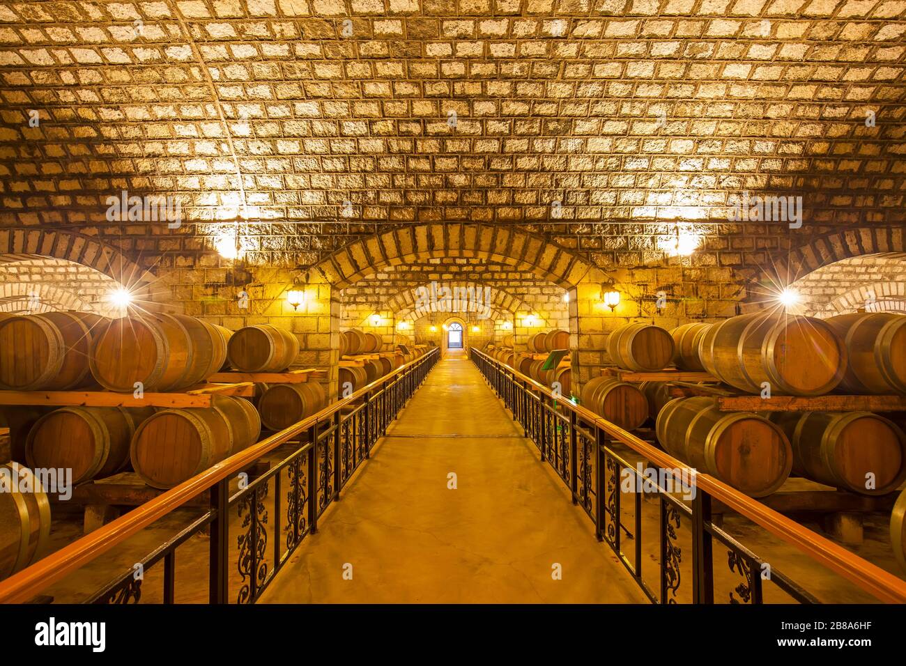 Wine barrels stacked in the cellar of the winery Stock Photo - Alamy