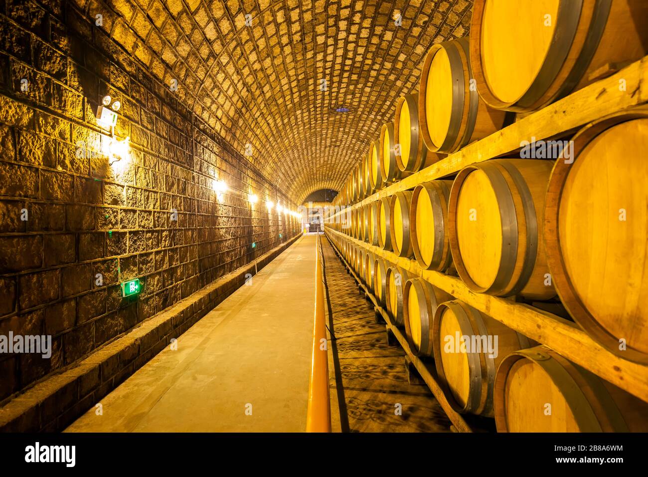 Wine barrels stacked in the cellar of the winery Stock Photo - Alamy