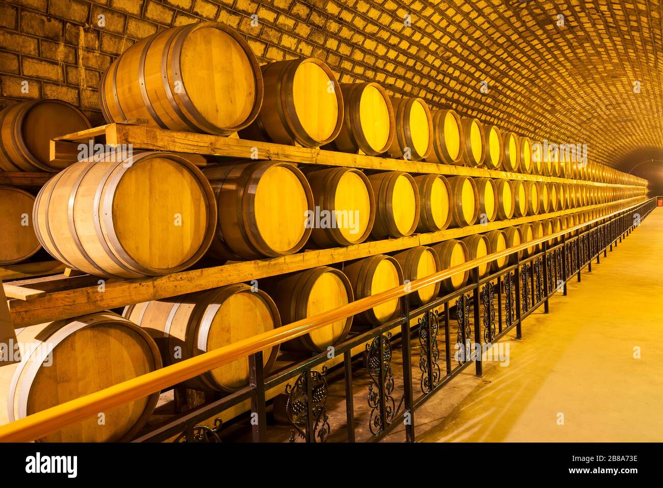 Wine barrels stacked in the cellar of the winery Stock Photo - Alamy