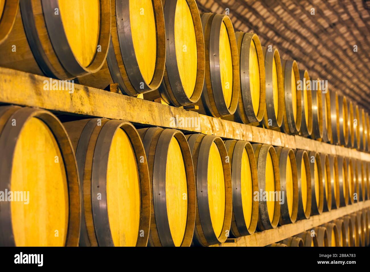 Wine barrels stacked in the cellar of the winery Stock Photo - Alamy