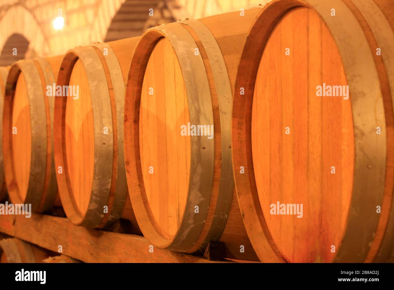 Wine barrels stacked in the cellar of the winery Stock Photo - Alamy