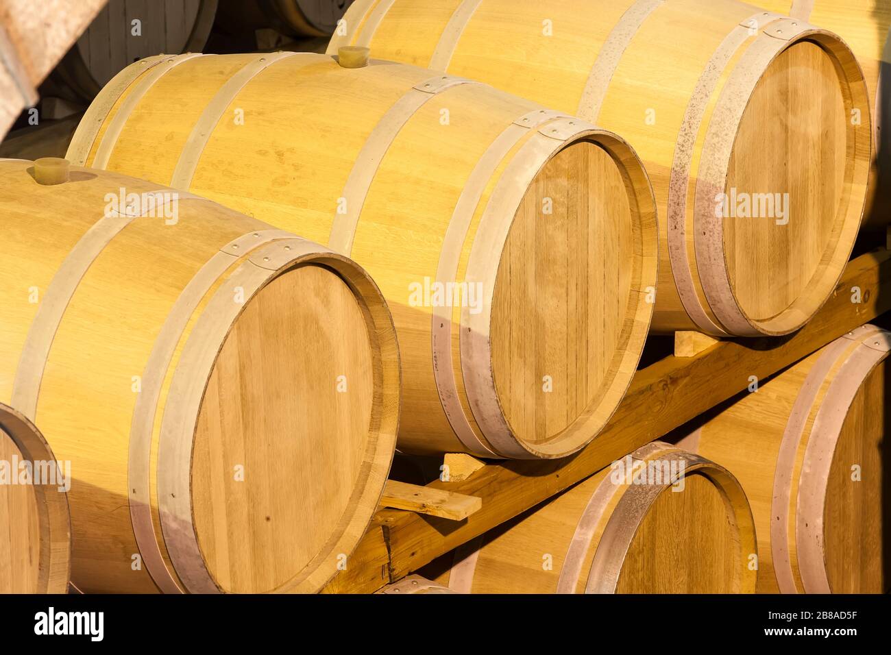 Wine barrels stacked in the cellar of the winery Stock Photo - Alamy