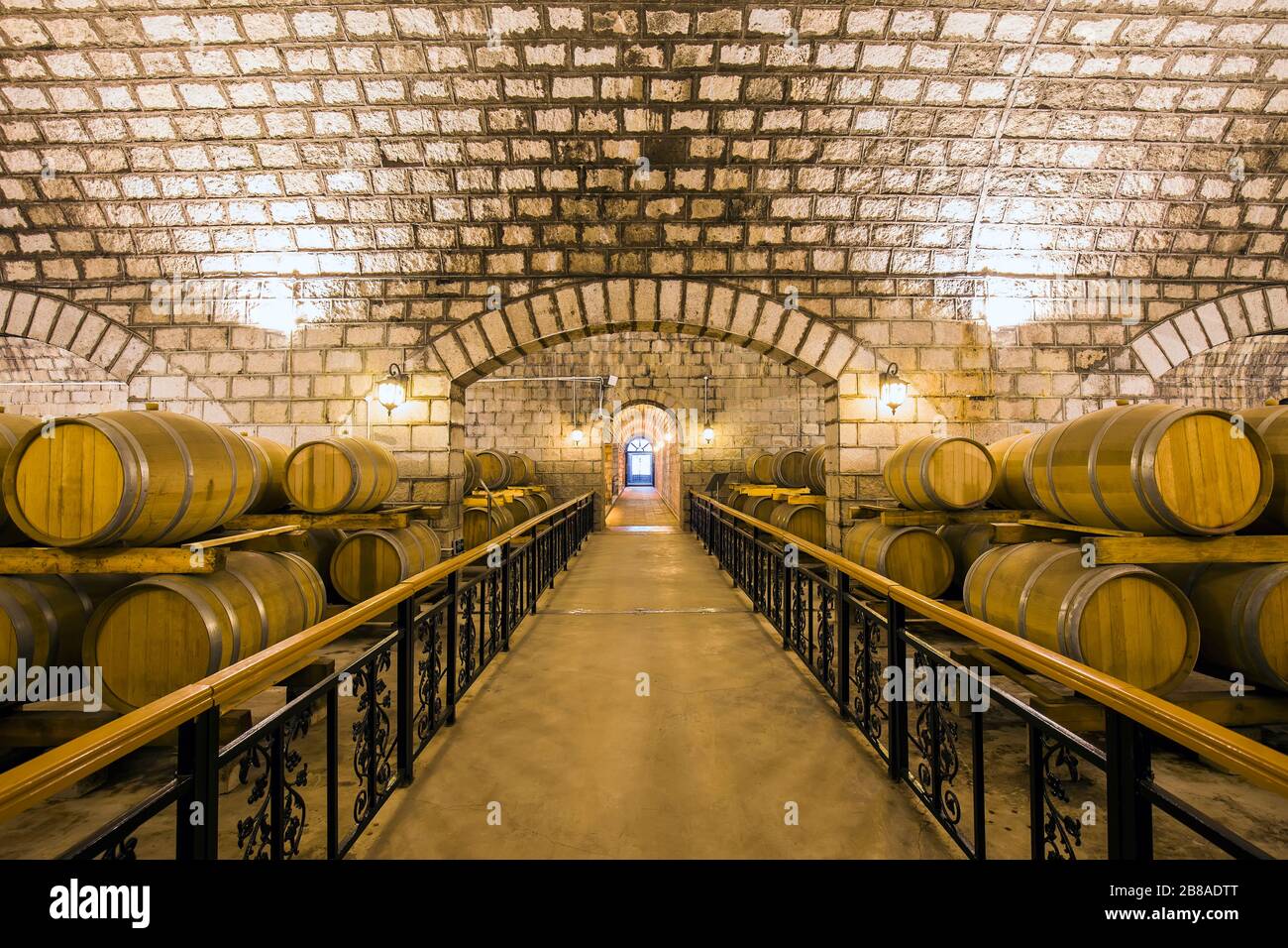 Wine barrels stacked in the cellar of the winery Stock Photo - Alamy